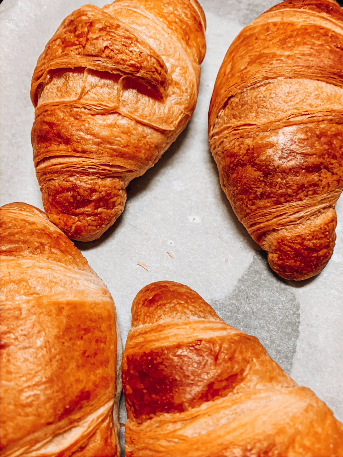 Golden croissants on baking paper